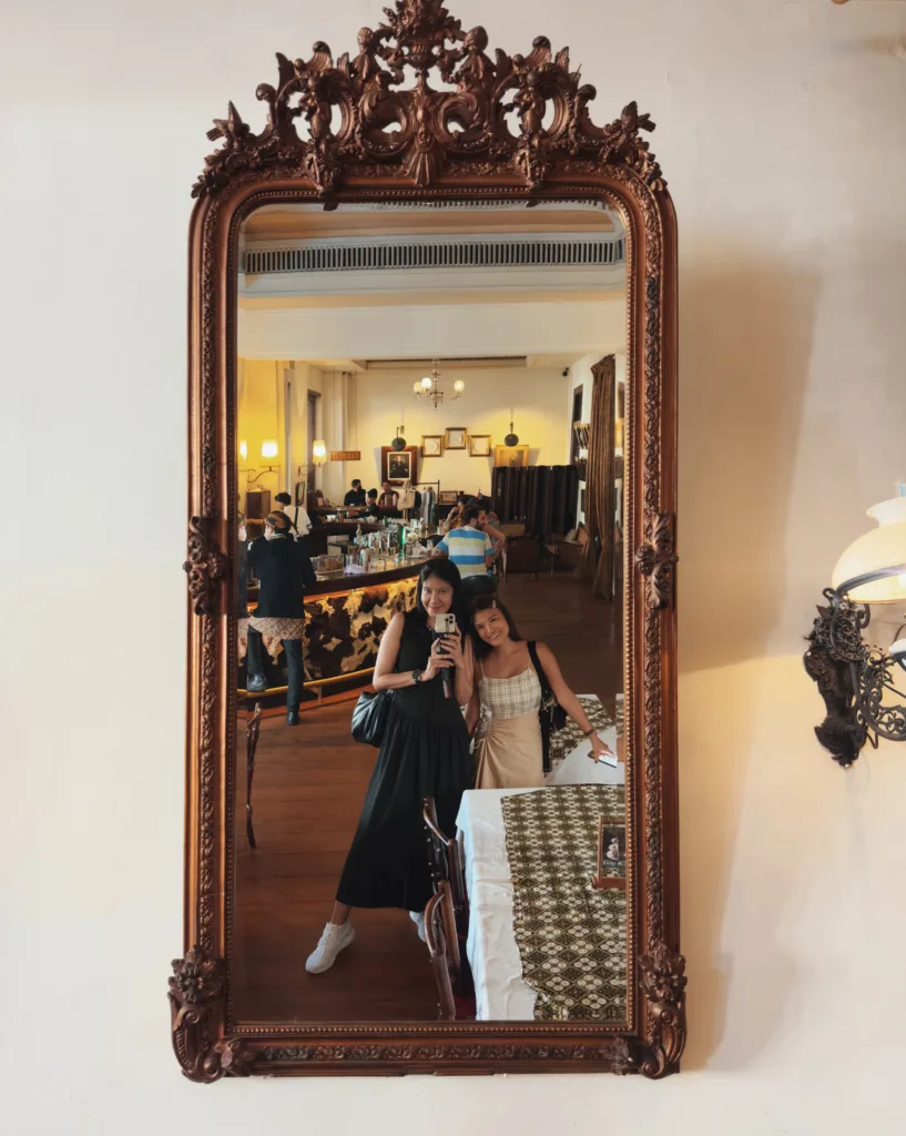 two women posing for a picture in a mirror Things to Do in Jakarta